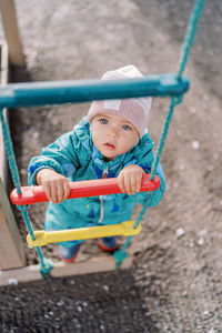 Portrait of boy sitting on slide