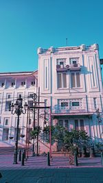 Low angle view of building against clear blue sky