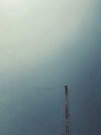 Low angle view of electricity pylon against sky