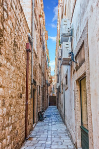 Narrow alley amidst buildings in town
