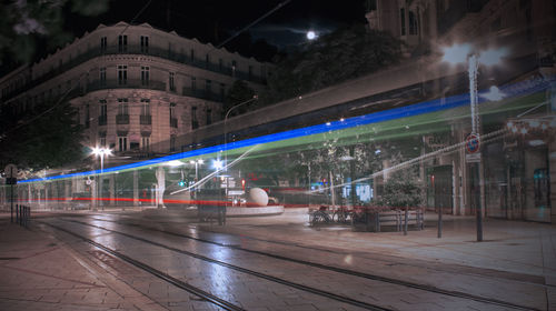 Illuminated city street and buildings at night