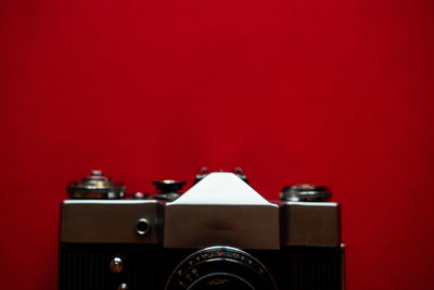 Close-up of camera against red background