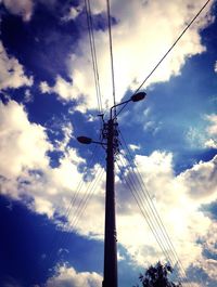 Low angle view of tree against cloudy sky