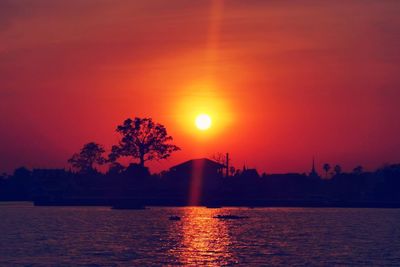 Scenic view of lake against romantic sky at sunset