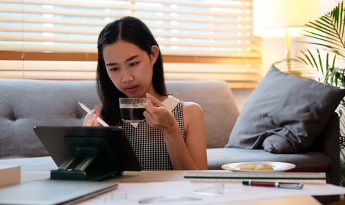 Businesswoman using laptop at home