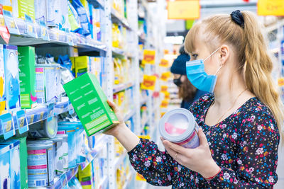 Woman holding ice cream in store