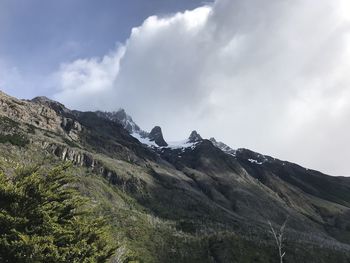 Scenic view of mountains against cloudy sky