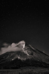 Scenic view of mountains against sky at night
