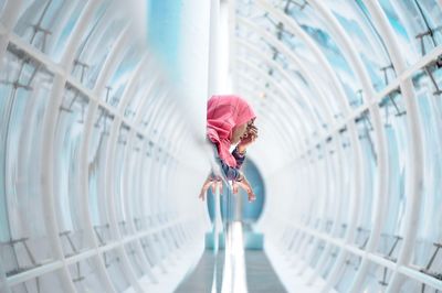 Woman standing on railing