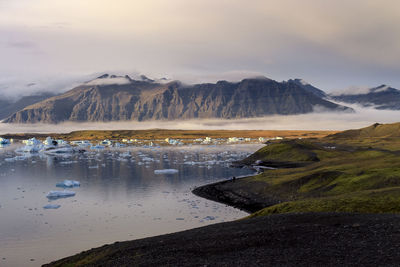 Scenic view of lake against sky during winter