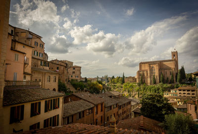 High angle view of buildings in town against sky