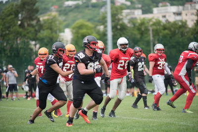 Group of people running on grassland