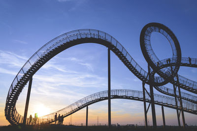 Low angle view of rollercoaster against sky