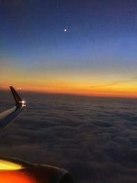 Cropped image of airplane flying over clouds