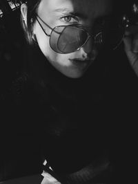 Close-up portrait of young woman wearing sunglasses