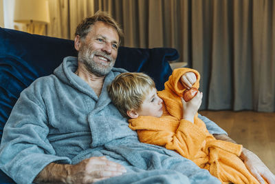 Portrait of smiling boy sitting at home