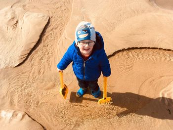 High angle view of boy on sand