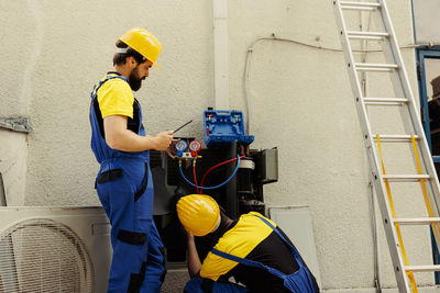 Rear view of man working at construction site