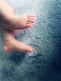 Low section of baby feet on rug