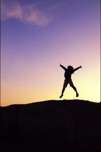 Silhouette of woman in mid-air