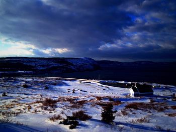 Scenic view of mountain range against cloudy sky