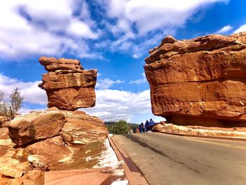 Rock formations against cloudy sky