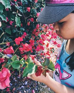 Close-up of woman looking at flowers