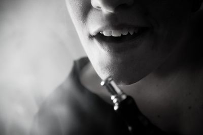 Midsection of person with hookah pipe