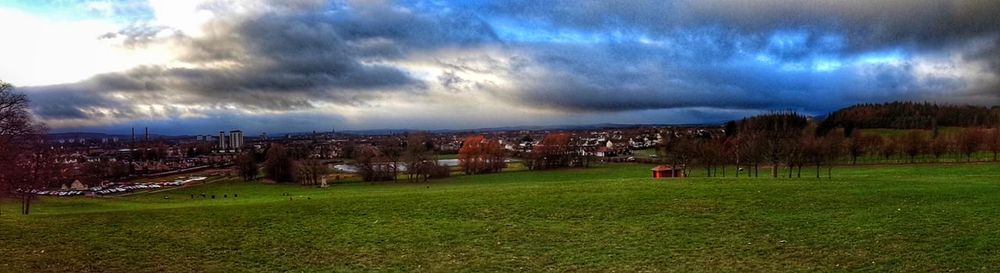 Panoramic shot of illuminated cityscape against sky