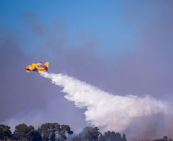 Low angle view of airshow against sky