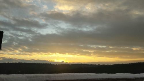 Scenic view of dramatic sky over landscape during sunset