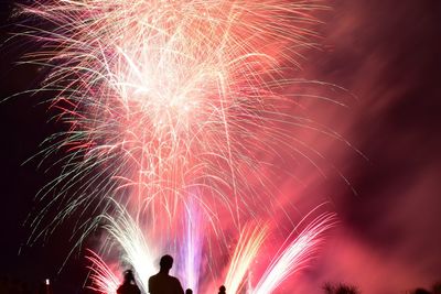 Low angle view of firework display at night