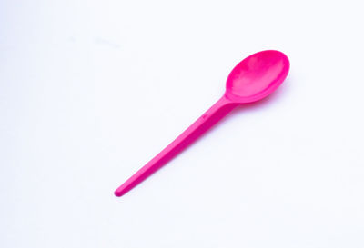 High angle view of pink knife on white background