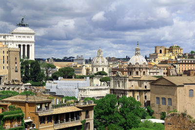 View of cathedral in city against cloudy sky