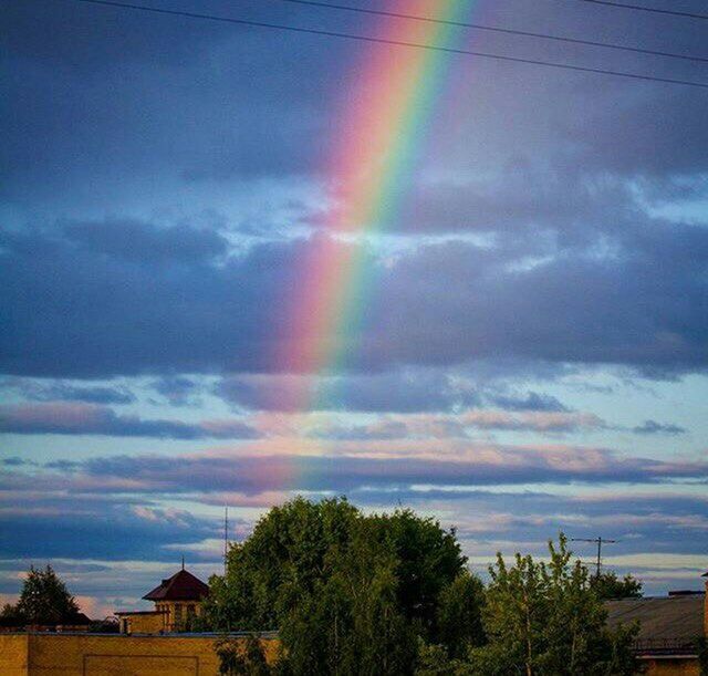 sky, rainbow, tree, cloud - sky, building exterior, built structure, architecture, multi colored, house, beauty in nature, scenics, cloudy, cloud, sunset, nature, tranquility, tranquil scene, low angle view, outdoors, dramatic sky