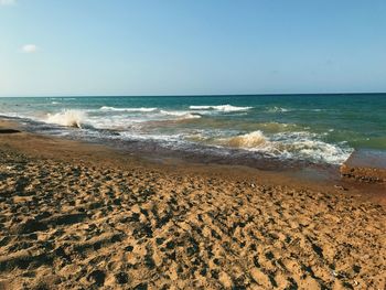 Scenic view of beach against clear sky