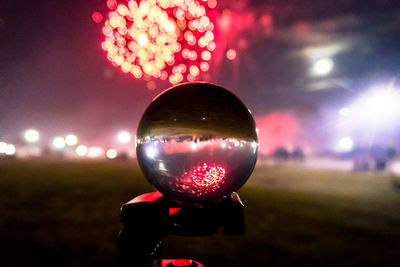 Close-up of bubbles in park against sky at night