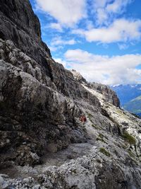 Low angle view of rocky mountains against sky