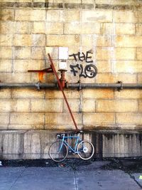 Bicycle parked against wall