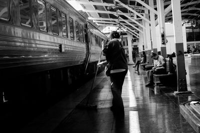 People walking on railroad station platform