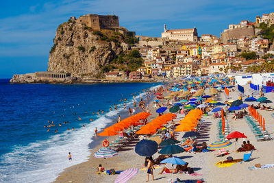 High angle view of people on beach by sea against sky