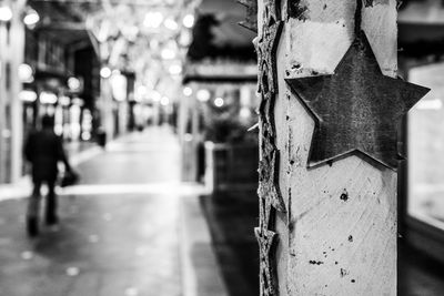 Close-up of chain hanging on footpath in city