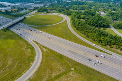 High angle view of road amidst trees and city