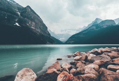 Scenic view of lake and mountains against sky