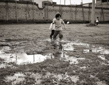 Boy playing soccer ball on field