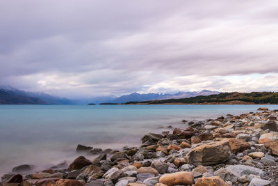 Scenic view of lake against cloudy sky