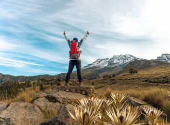 Rear view of man standing on mountain