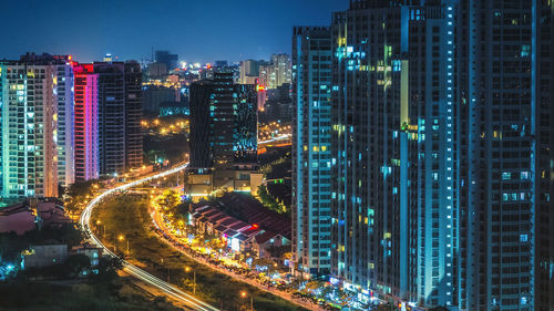 High angle view of road amidst buildings at night