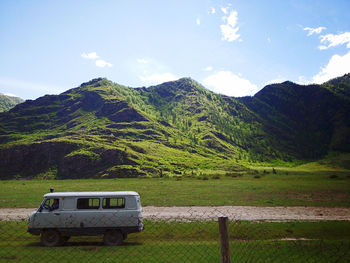 Abandoned truck on mountain against sky