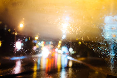 Close-up of illuminated wet glass